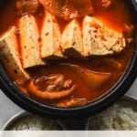 kimchi jjigae with tofu in black clay pot