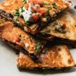 wedges of black bean kimchi quesadilla arranged on a plate
