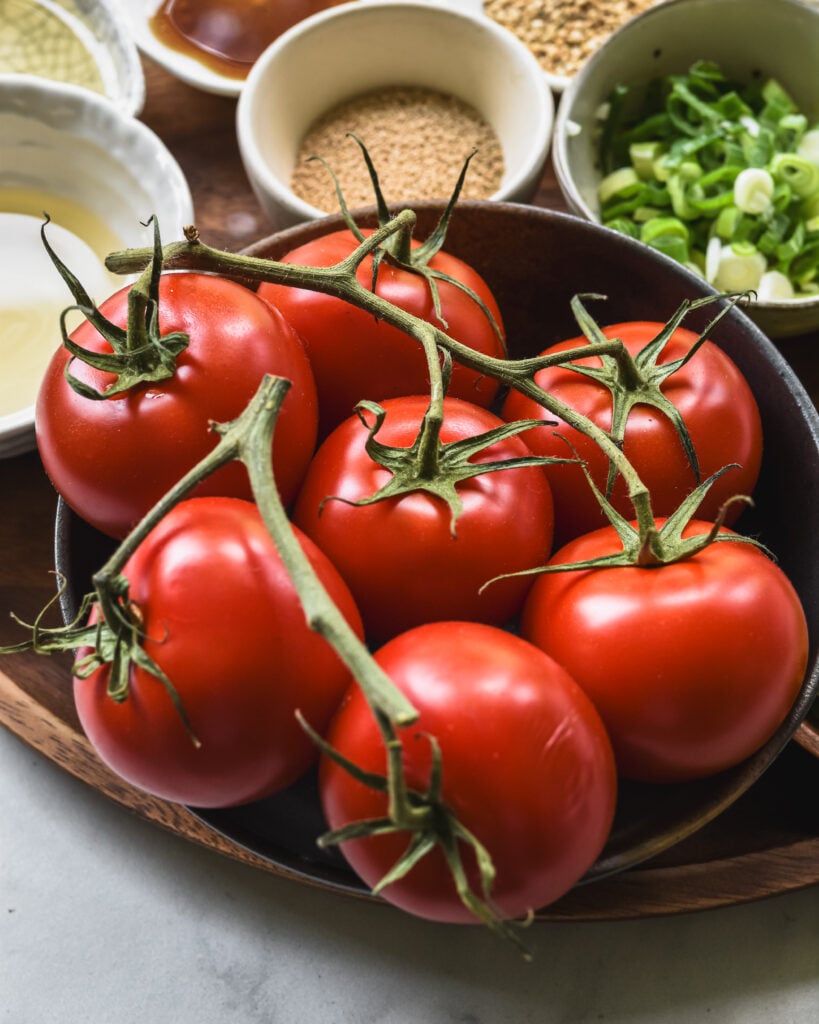 red tomatoes attached to a vine