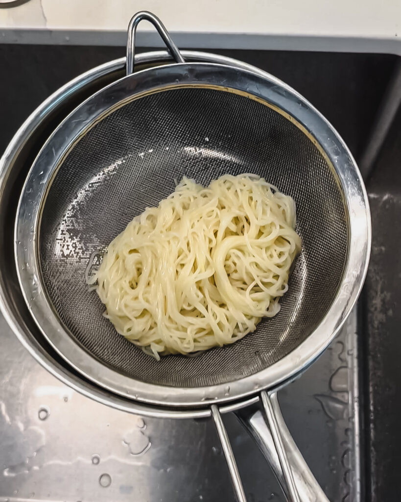 somyeon noodles (somen) in fine mesh sieve
