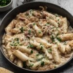 carbonara tteokbokki (korean rice cakes) in serving dish